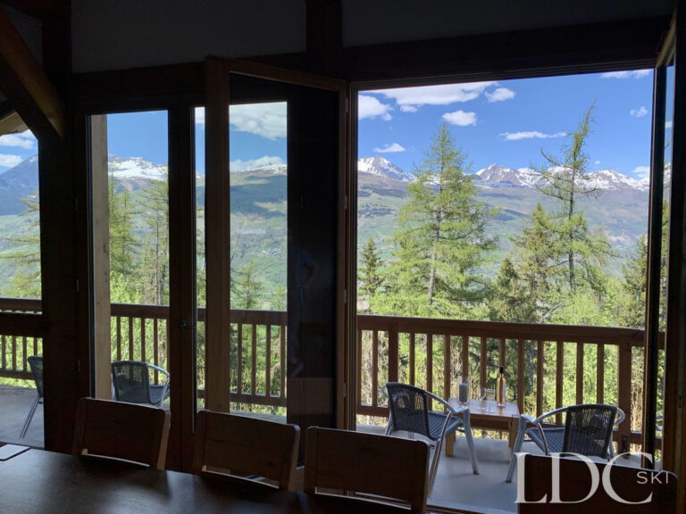 Panoramic mountain view through the large windows at Chalet Flocon in Les Coches, La Plagne