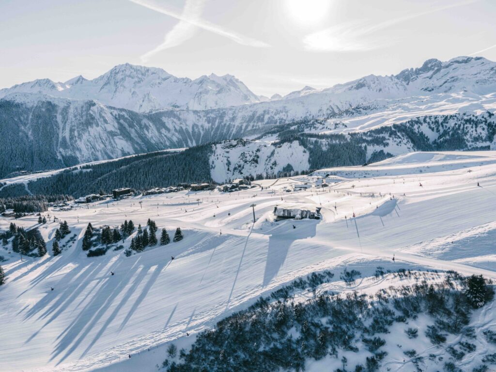 Aerial winter panorama across Jardin Alpin, Pralong and the surrounding Courchevel ski area. © Un Duo.