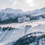 Aerial winter panorama across Jardin Alpin, Pralong and the surrounding Courchevel ski area. © Un Duo.
