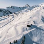 Aerial winter view across the ski slopes around the Altiport and Pralong in Courchevel 1850. © Un Duo.