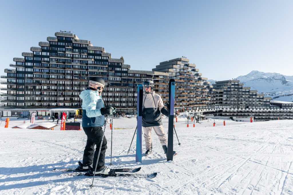 Skiers in front of the distinctive buildings of Plagne Aime 2000 – © Brendan Le Peru / La Plagne