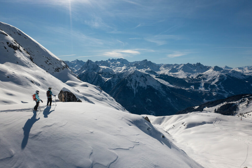 Skiers exploring off-piste terrain above Champagny-en-Vanoise in La Plagne – © La Plagne / JYM