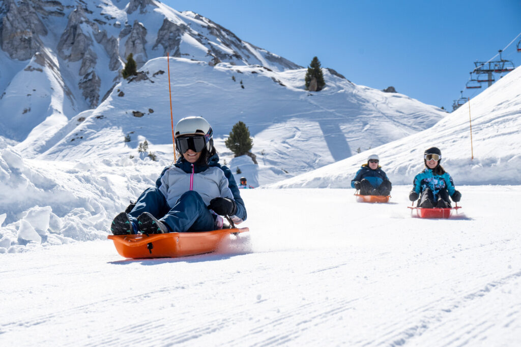 Family enjoying the Colorado Luge on the snowy slopes of La Plagne – © JNJ Photo / La Plagne