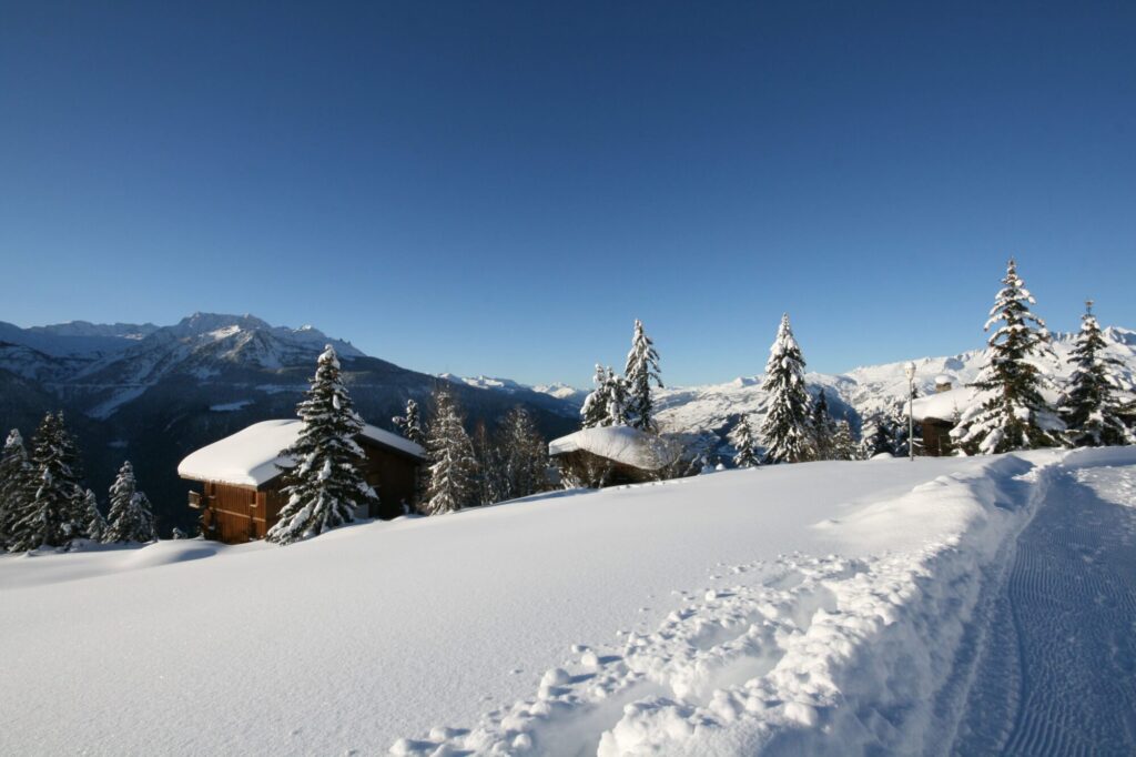 Traditional chalet surrounded by deep snow and mountain scenery in La Rosière