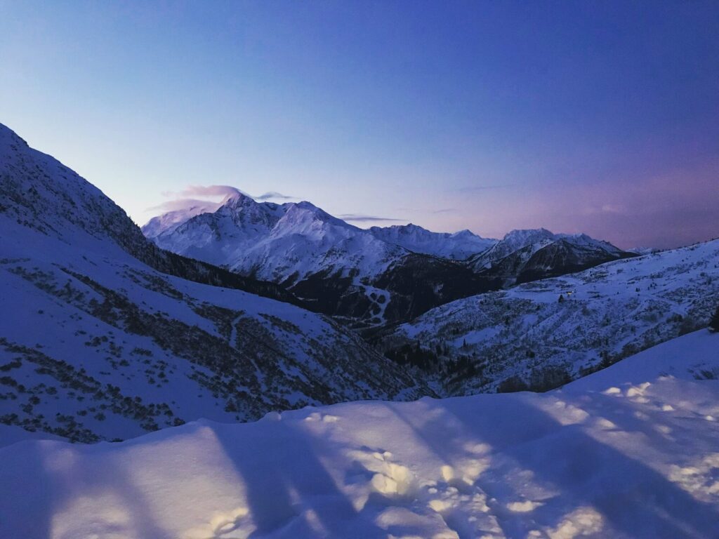 Mont Pourri at dusk viewed across the snowy mountains from La Rosière