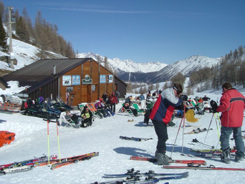 Skiers stopping at a mountain restaurant beside the slopes in La Rosière