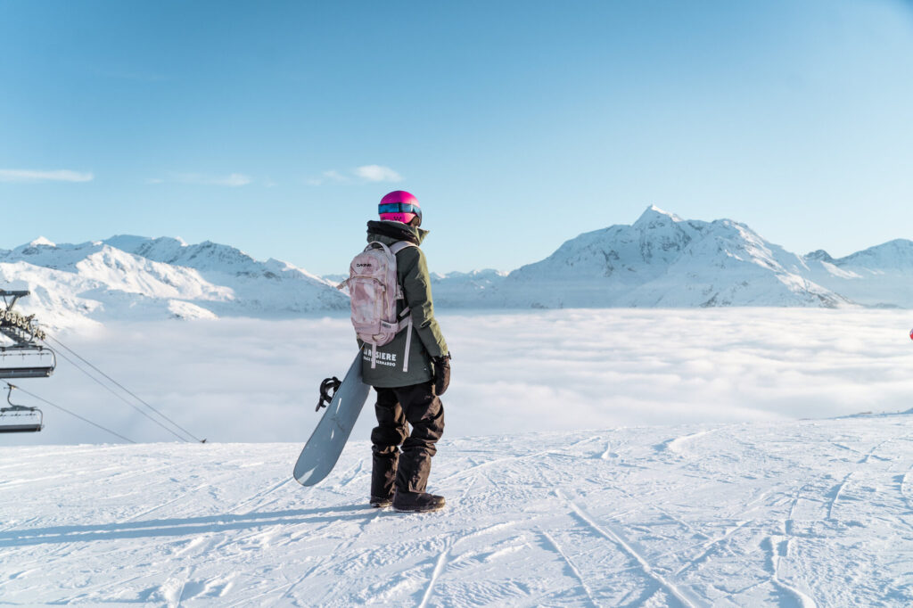 Skier looking across a spectacular sea of clouds from the slopes of La Rosière