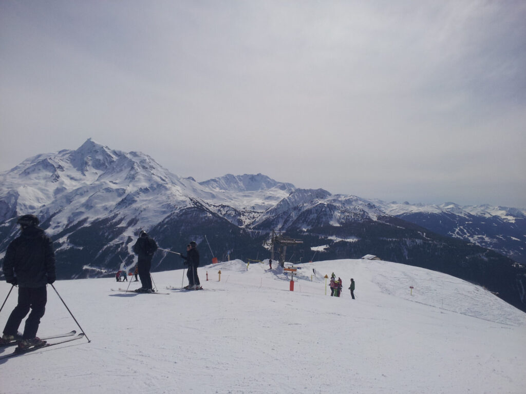 Skiers enjoying the snowy pistes and mountain views in La Rosière