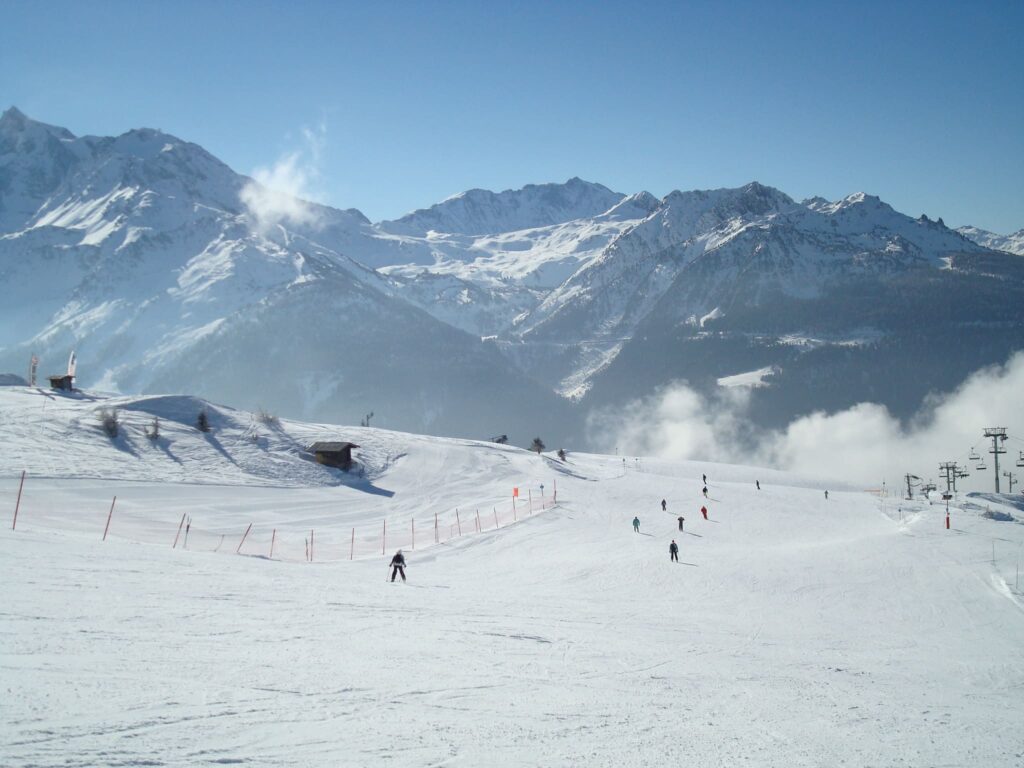 Skiers enjoying the wide sunny pistes of La Rosière