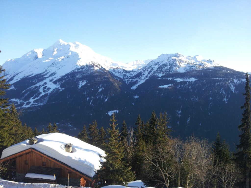 Snow-covered chalet beneath the mountains in La Rosière