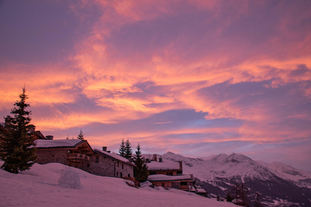 Pink winter sunrise over the snow-covered mountains of La Rosière