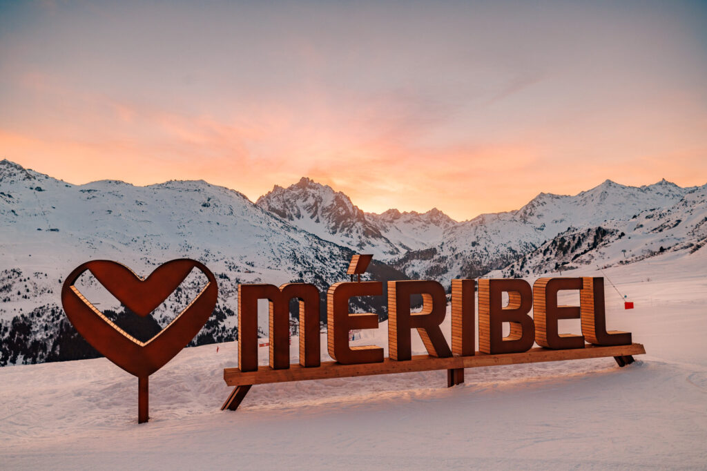 Méribel heart sign beneath a colourful winter sunset