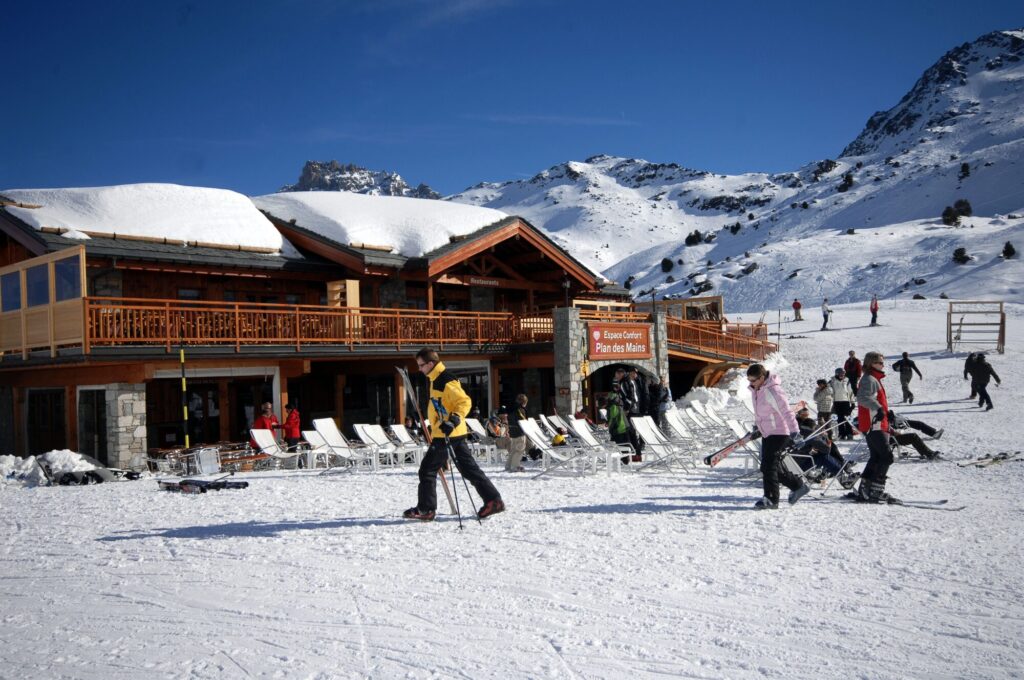 Skiers outside a mountain restaurant beside the slopes in Méribel