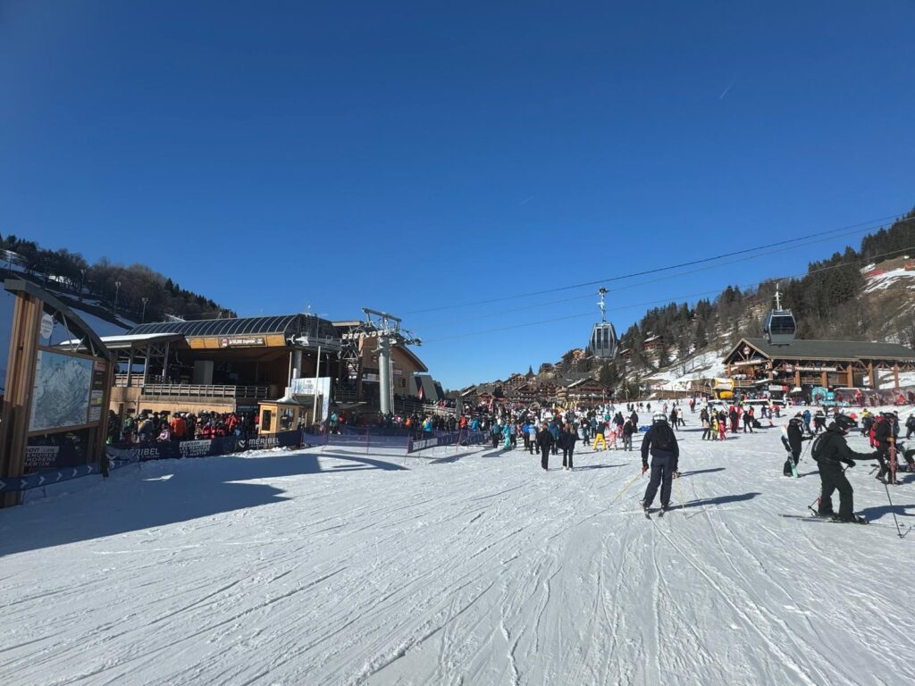 Skiers gathering beside the lifts at a Méribel ski area base