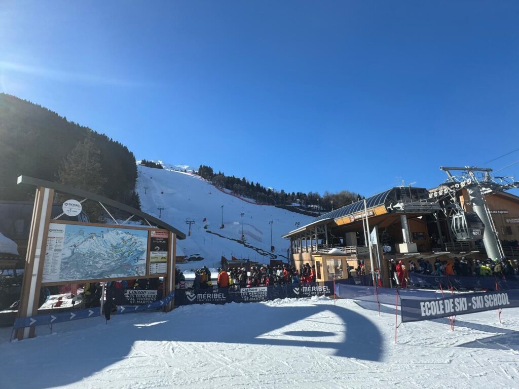 Skiers at a lift station in the Méribel ski area
