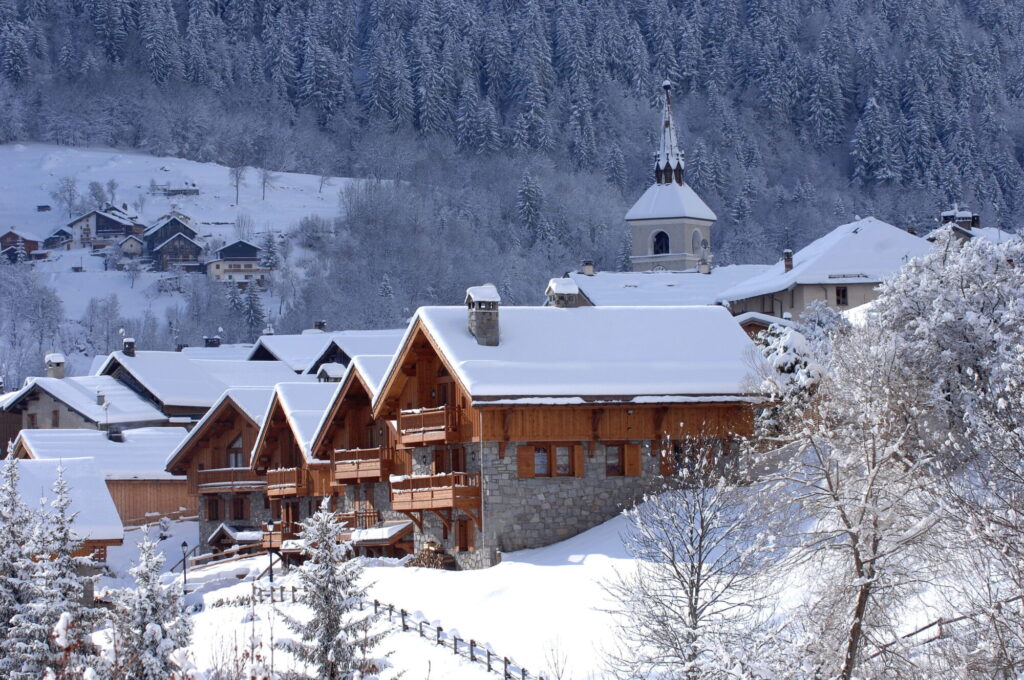 Traditional chalets and church surrounded by deep snow in Méribel