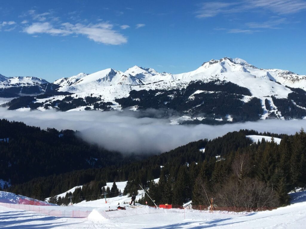 Snow-covered mountain peaks rising above the clouds from Morzine