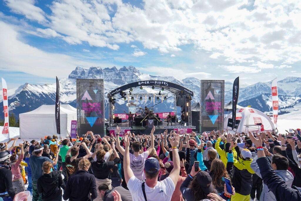 Crowds enjoying a live Rock the Pistes concert on the mountain