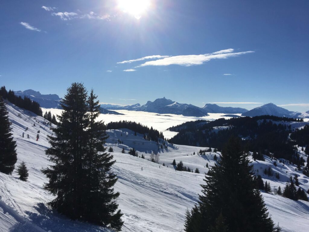 Sunny snow-covered slopes and mountain views in the Morzine ski area