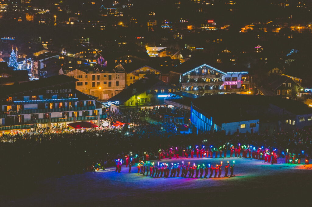 Illuminated torchlight ski descent on the slopes above Morzine at night