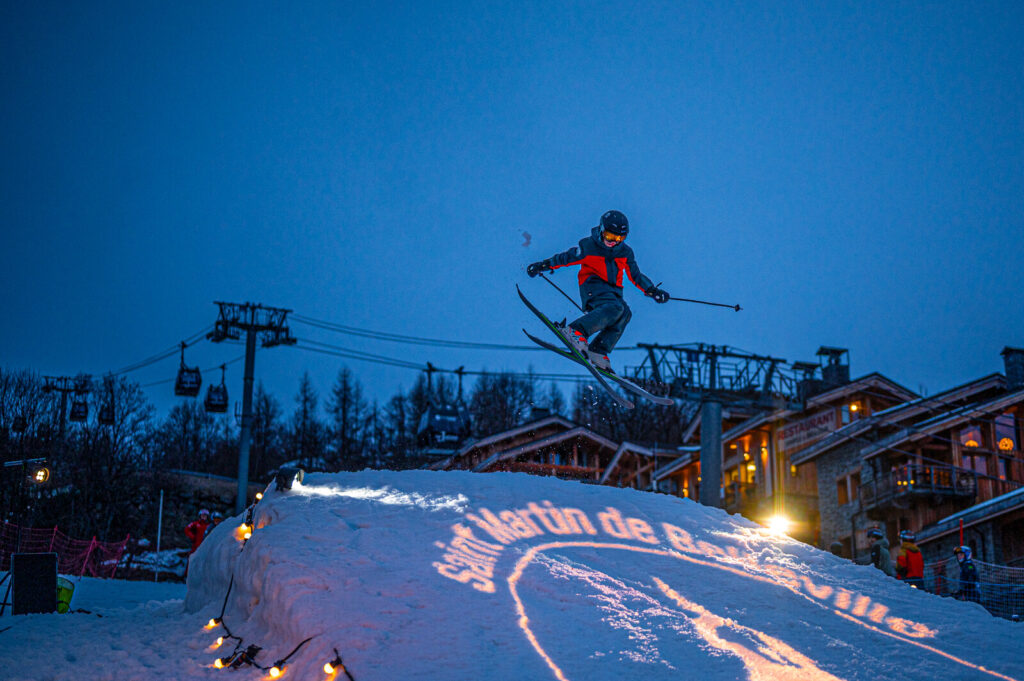 Skier performing during an evening winter event in St Martin de Belleville