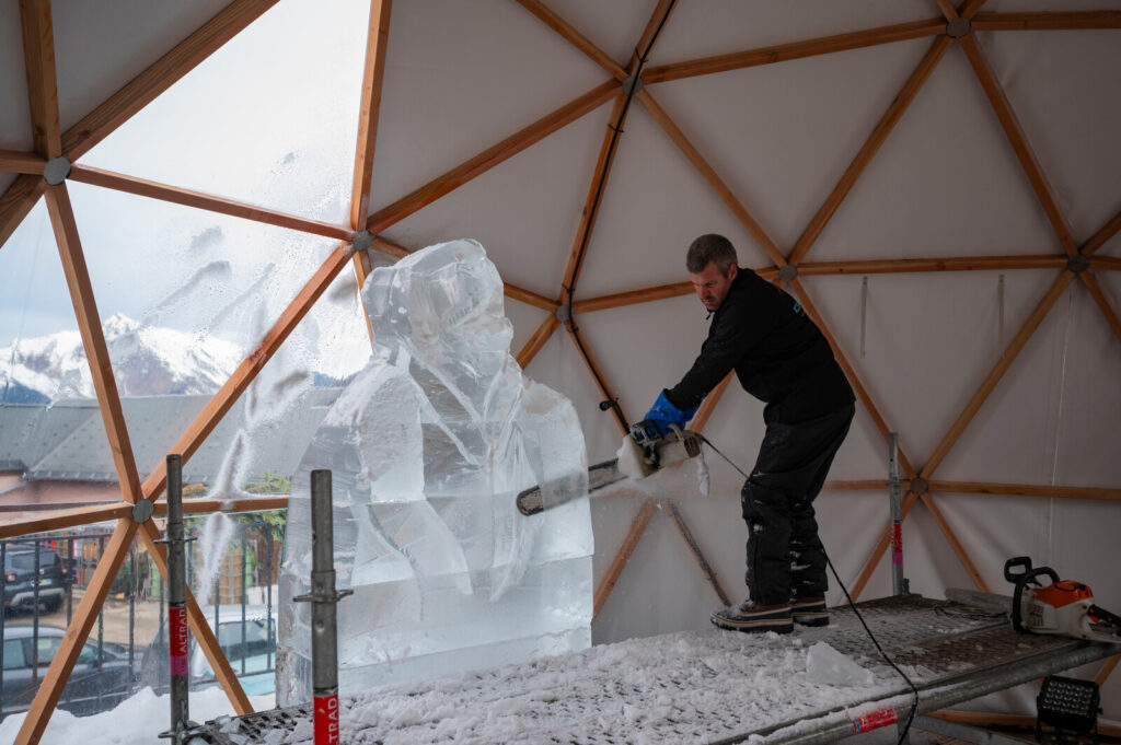 Ice sculptor creating a winter display in St Martin de Belleville