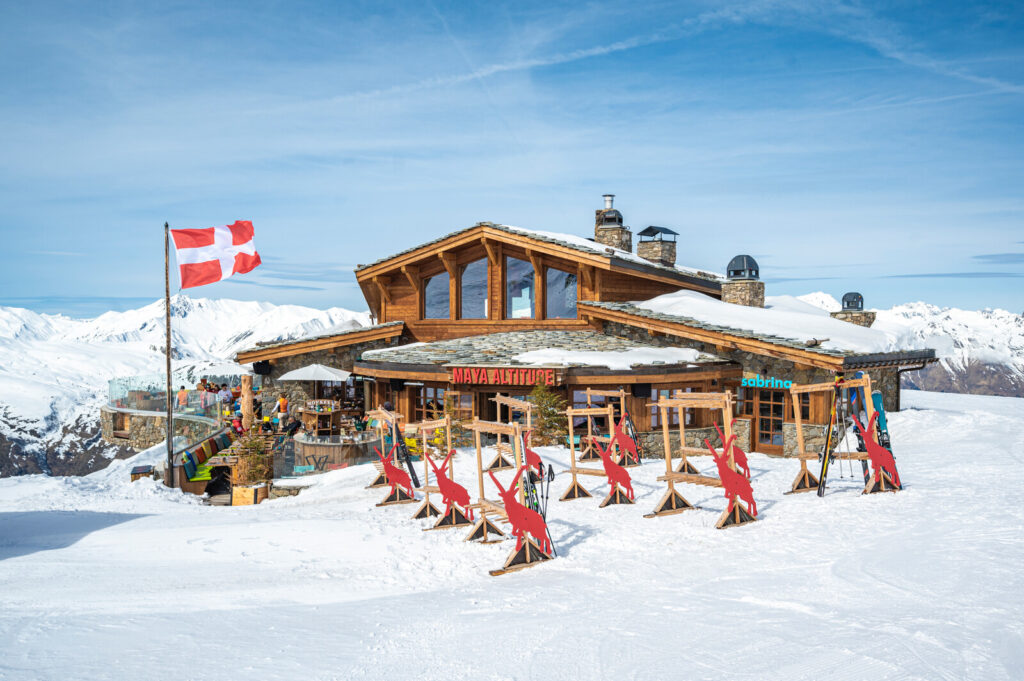 Mountain restaurant surrounded by snowy peaks above St Martin de Belleville