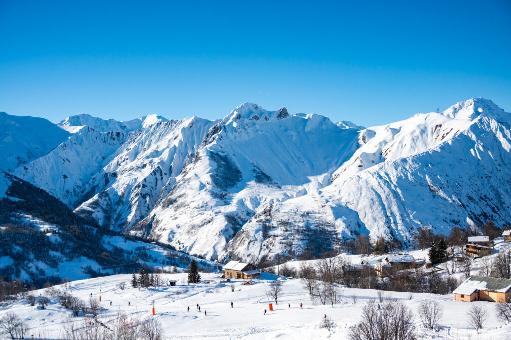 Skiers enjoying the slopes and mountain scenery above St Martin de Belleville