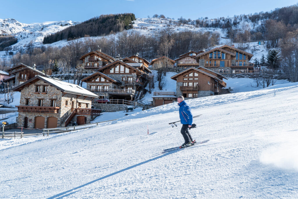 Skier descending a piste towards St Martin de Belleville