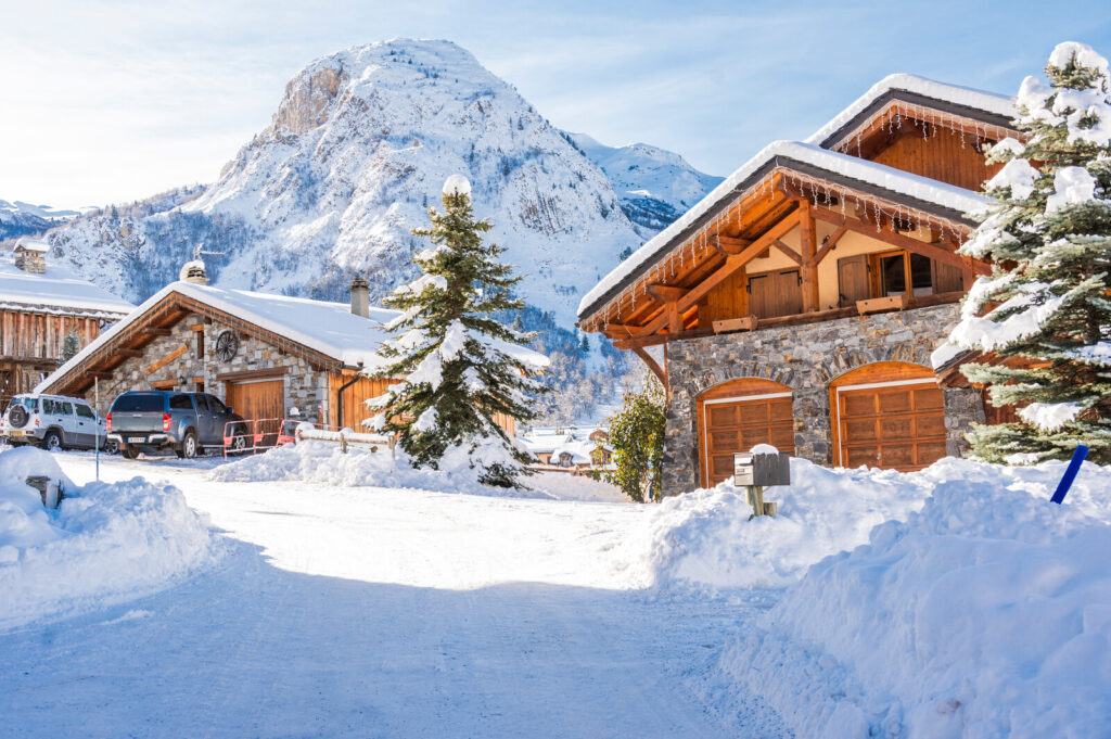 Traditional snow-covered chalets with dramatic mountain scenery in St Martin de Belleville
