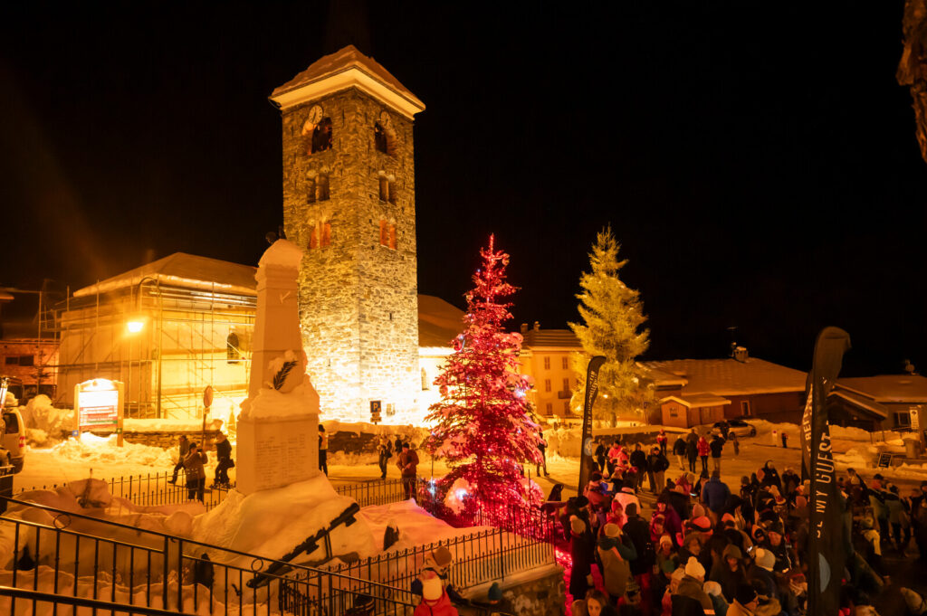 Historic church surrounded by traditional snow-covered buildings in St Martin de Belleville