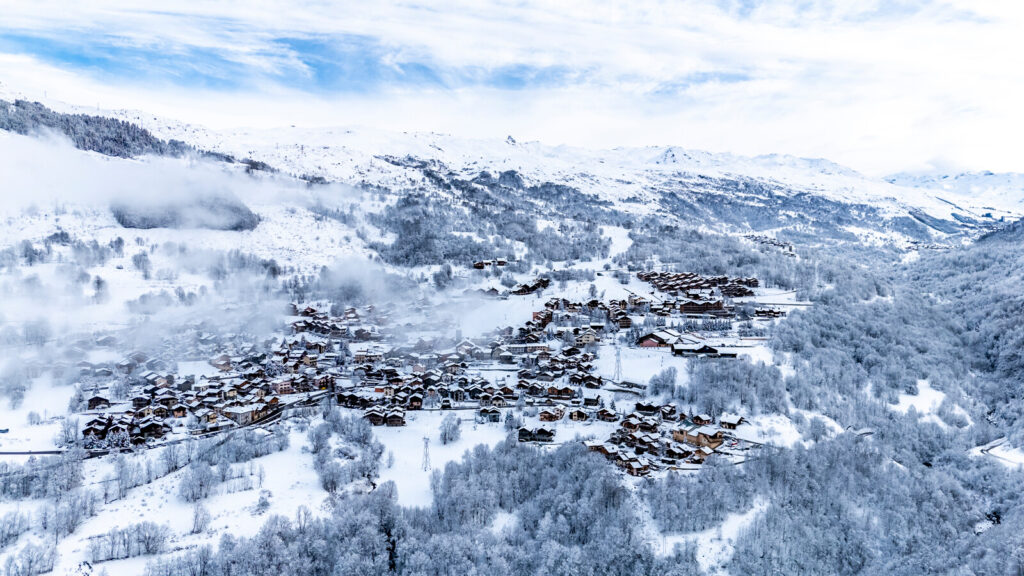 Aerial winter view of St Martin de Belleville surrounded by snowy mountains