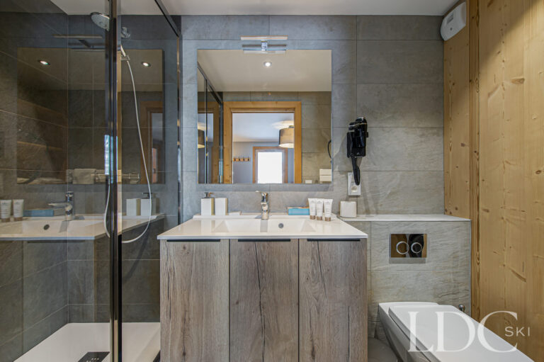 En-suite bathroom at Prestige No.5 with double basins and glass walk-in shower