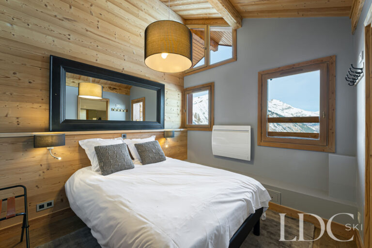 Double bedroom at Prestige No.5 with timber panelling and mountain views