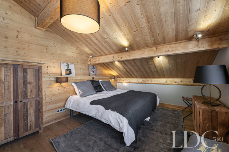 Double bedroom at Prestige No.5 beneath a timber-clad sloping ceiling
