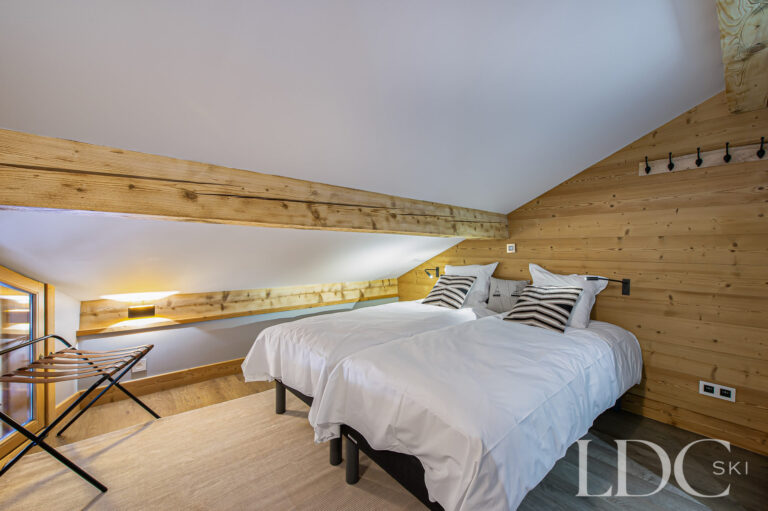 Double bedroom at Prestige No.5 with timber walls and exposed beams