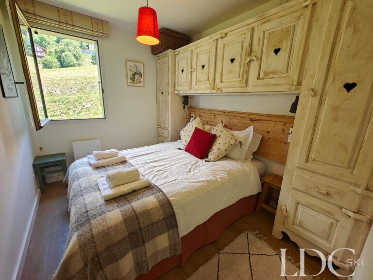 Biollay 43 double bedroom with alpine-style fitted wardrobes and hillside views