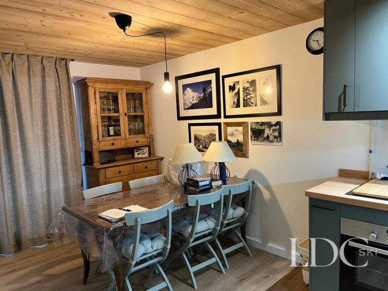 Biollay 43 dining area with alpine-style furnishings and open-plan kitchen