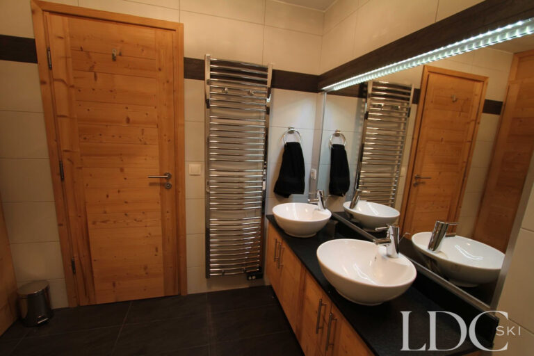Biollay 53 bathroom with double basins, large mirror and heated towel rails