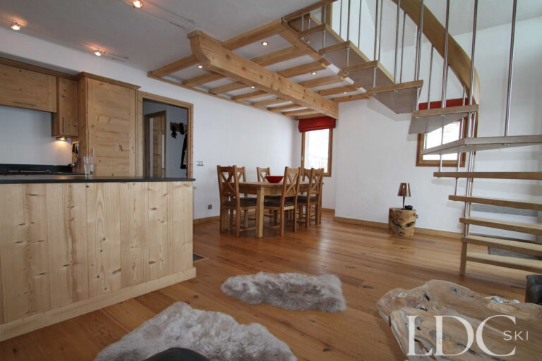 Biollay 53 open-plan lounge, kitchen and dining area with contemporary staircase