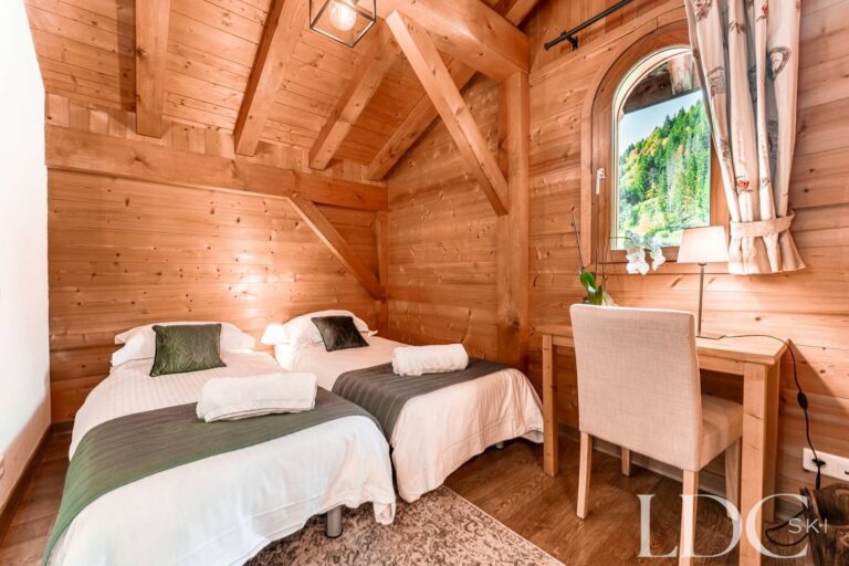 Twin bedroom with mountain views at Cairn Lodge in Morzine