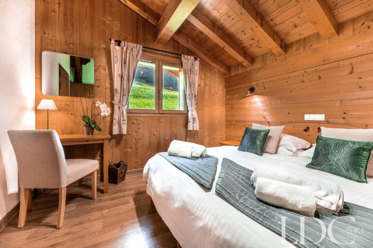 Double bedroom with traditional timber interior at Cairn Lodge