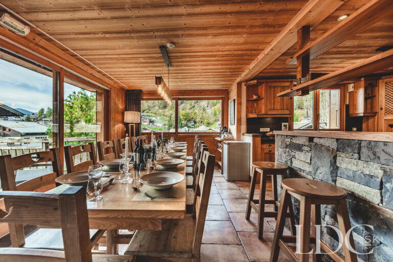 Large dining room with extensive windows and mountain views at Cairn Lodge in Morzine