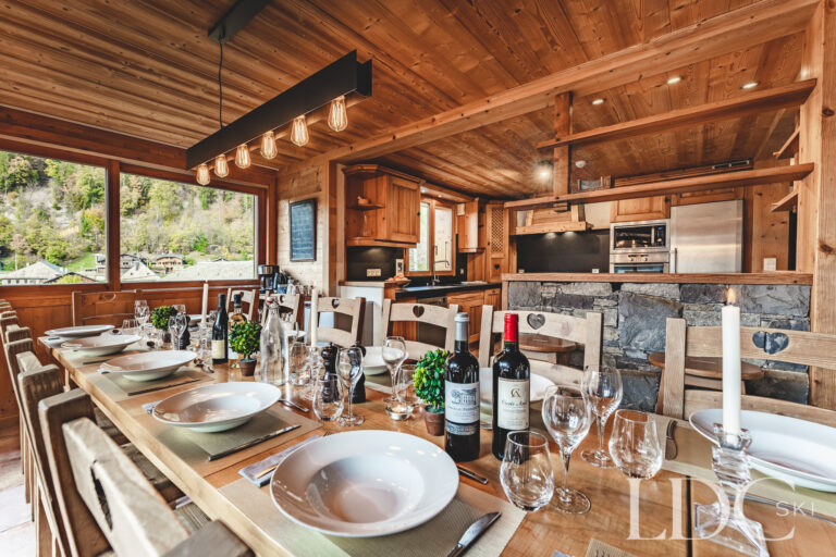 Sociable dining room with panoramic mountain views at Cairn Lodge in Morzine