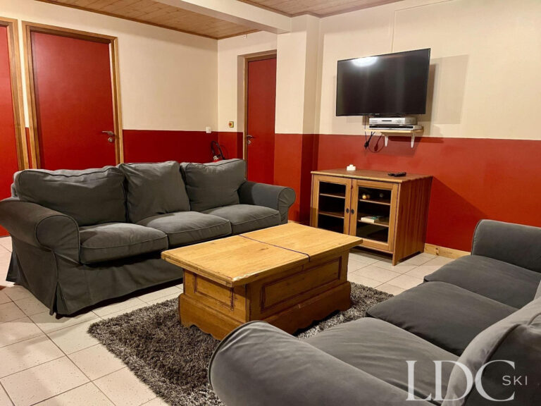 Games room with sofas and television at Cairn Lodge in Morzine