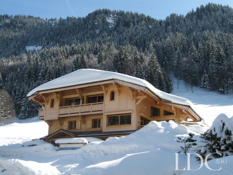 Snow-covered exterior of Cairn Lodge in Morzine
