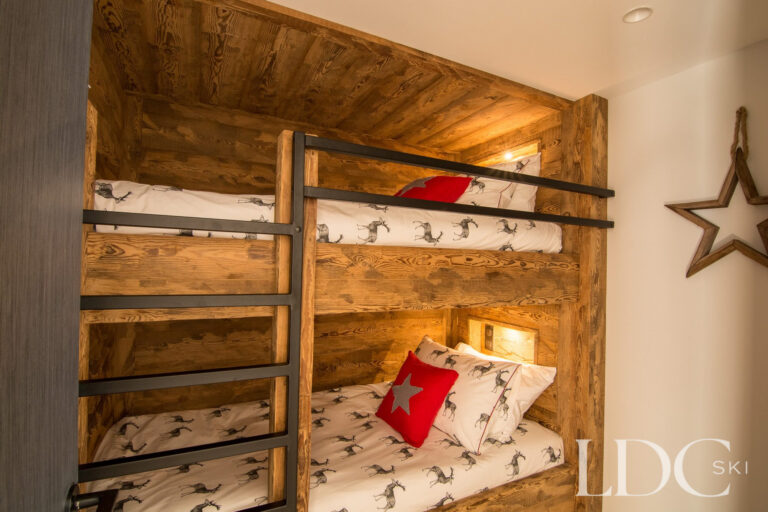 Wooden bunk beds with alpine bedding at Chalet Astilla in St Martin de Belleville