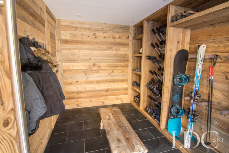 Wood-panelled ski and boot room with ski, snowboard and boot storage at Chalet Astilla in St Martin de Belleville