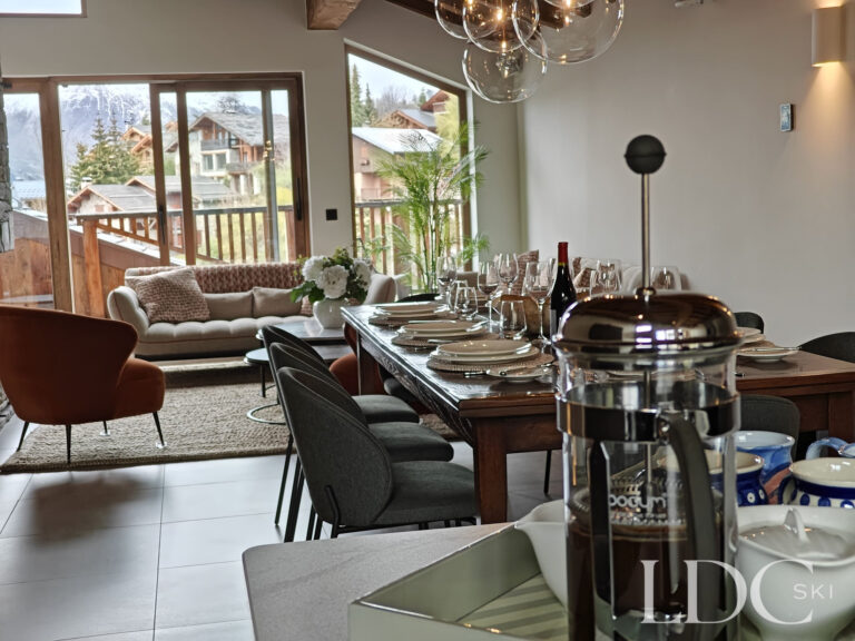Dining table and pendant lighting in the open-plan living space at Chalet Chardon