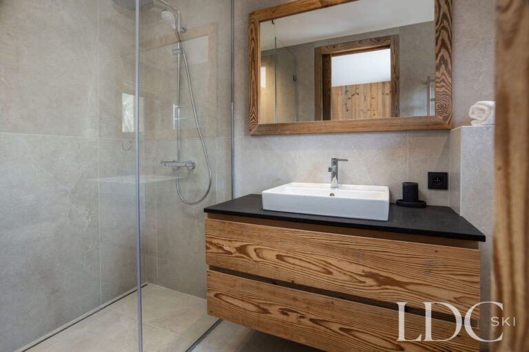 Chalet Aurea shower room with walk-in shower and timber vanity